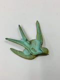 Antique small metal flying swallow bird
