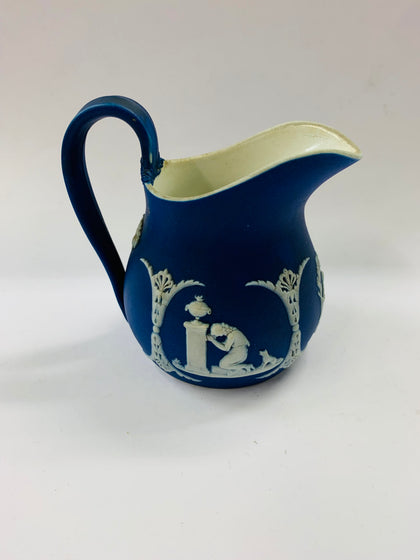 Dark blue Wedgwood jug with unique floral design on the handle
