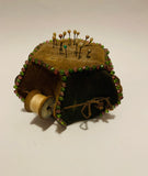 Antique pin cushion with cotton reels