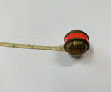 Antique tape measure with geometric floral design