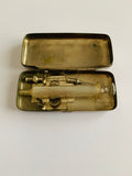 Antique medical surgical syringe in a metal case