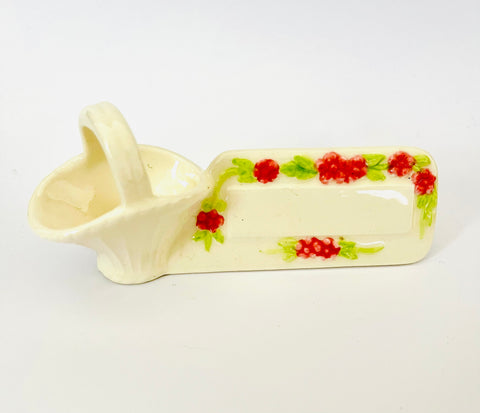 Eight Porcelain name plates with flower baskets attached ￼