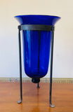 Large cobalt blue glass bell vase in a metal holder