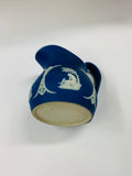 Dark blue Wedgwood jug with unique floral design on the handle
