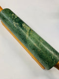 Green marble rolling pin on wooden base