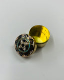 Antique brass pill box with enamel design lid