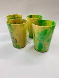4 mottled Bakelite cups in a leather case