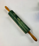 Green marble rolling pin on wooden base