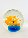Clear Paperweight with Blue Base and Orange Swirl Flower