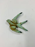 Antique small metal flying swallow bird