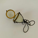 Ornate Victorian milk glass egg in brass wire stand jewellery holder