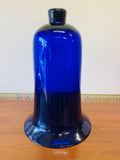 Large cobalt blue glass bell vase in a metal holder