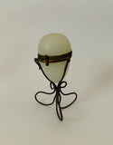 Ornate Victorian milk glass egg in brass wire stand jewellery holder