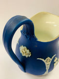 Dark blue Wedgwood jug with unique floral design on the handle