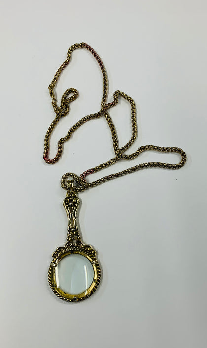 Vintage magnifying glass on gold tone rope chain