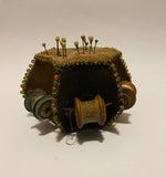 Antique pin cushion with cotton reels
