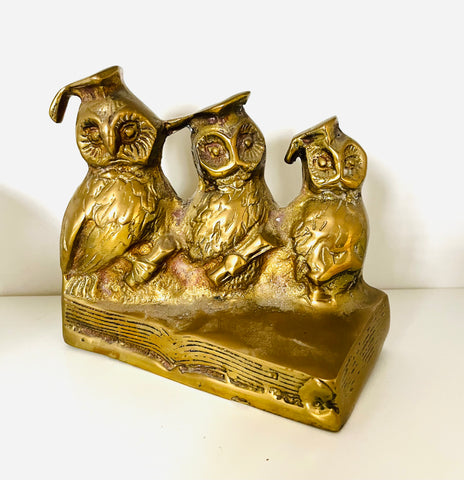 3 Brass Owls sitting in a book