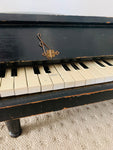 Antique child’s baby grand piano