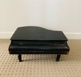 Antique child’s baby grand piano