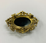 Vintage brooch with gold detail and black stone