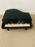 Antique child’s baby grand piano