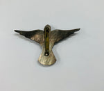 Paua Shell and mother of Pearl cross brooch on a bird