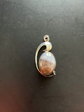 Sterling Silver Pendant with an Oval Brown and White Stone with Wave Design